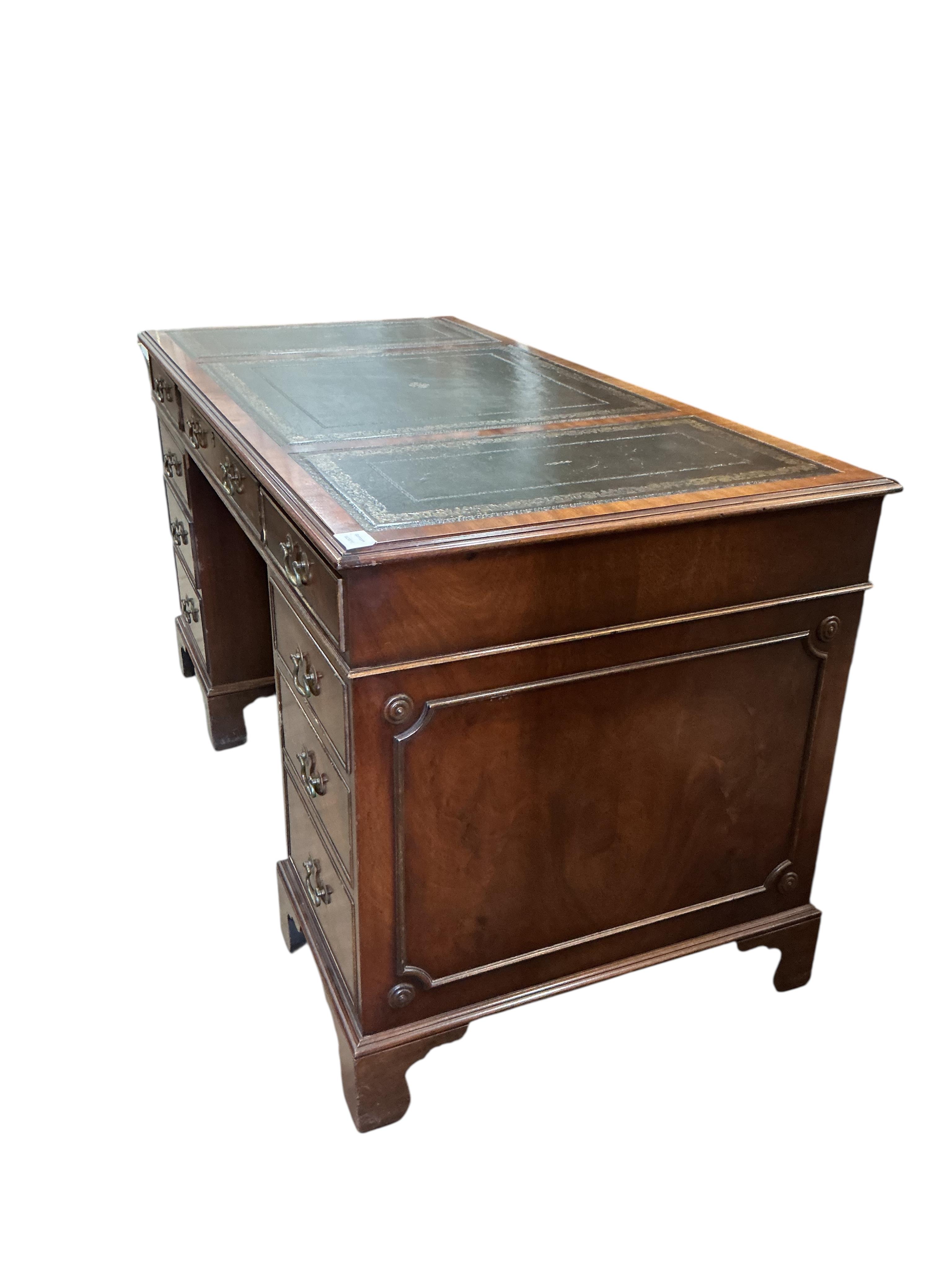 A reproduction mahogany pedestal desk, width 140cm, depth 68cm, height 76cm